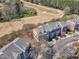 Aerial view of townhomes backing onto a golf course, showcasing community layout and proximity to recreational amenities at 3001 Imperial Oaks Dr, Raleigh, NC 27614