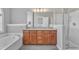 Bright bathroom features double sink vanity, soaking tub, and glass-enclosed shower at 3001 Imperial Oaks Dr, Raleigh, NC 27614