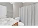 Clean bathroom featuring a light wood vanity, neutral walls, and a shower with a curtain at 3001 Imperial Oaks Dr, Raleigh, NC 27614