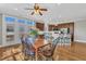 Open dining area with adjacent kitchen, breakfast bar, and access to outdoor patio at 3001 Imperial Oaks Dr, Raleigh, NC 27614