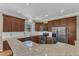 This eat-in kitchen boasts dark cabinets, stainless steel appliances, and granite counters at 3001 Imperial Oaks Dr, Raleigh, NC 27614