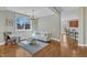 Inviting living area features hardwood floors, a plush sofa and access to kitchen at 3001 Imperial Oaks Dr, Raleigh, NC 27614