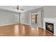 Bright living room featuring hardwood floors, a fireplace, and sliding glass doors to the patio at 3001 Imperial Oaks Dr, Raleigh, NC 27614