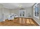 Bright living room with hardwood floors, French doors, and two white armchairs at 3001 Imperial Oaks Dr, Raleigh, NC 27614