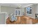 Bright living room with hardwood floors, French doors, and two white armchairs at 3001 Imperial Oaks Dr, Raleigh, NC 27614
