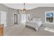 Large main bedroom with plush carpet, ceiling fan, and bright windows at 3001 Imperial Oaks Dr, Raleigh, NC 27614