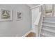 Bright stairway featuring gray walls, hardwood floors, carpeted stairs, and modern decor at 3001 Imperial Oaks Dr, Raleigh, NC 27614