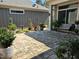 Serene backyard area featuring a paver patio, lush plants, and a bench at 3009 Kildaire Dairy Way, Apex, NC 27539