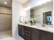 Bathroom featuring double sink vanity, quartz countertops, and a glass shower at 3009 Kildaire Dairy Way, Apex, NC 27539