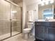 Bathroom featuring a stand up shower, grey tile, and a modern vanity with sink and faucet at 3009 Kildaire Dairy Way, Apex, NC 27539