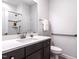 Modern bathroom featuring a single sink vanity, sleek fixtures, and tiled floor at 3009 Kildaire Dairy Way, Apex, NC 27539