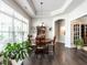 Elegant dining area with large window, wooden table, and decorative lighting at 3009 Kildaire Dairy Way, Apex, NC 27539