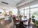 Bright dining area with a large window, dark wood table, and open concept kitchen view at 3009 Kildaire Dairy Way, Apex, NC 27539