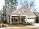 Charming single-Gathering home with stone accents, a well-manicured lawn, and an attached garage at 3009 Kildaire Dairy Way, Apex, NC 27539