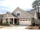 Charming single-Gathering home with a well-manicured lawn and a two-car garage and stone details at 3009 Kildaire Dairy Way, Apex, NC 27539