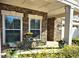 Inviting front porch with stone accents, perfect for relaxing and enjoying the outdoors. Seating area at 3009 Kildaire Dairy Way, Apex, NC 27539