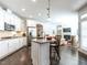 Modern kitchen featuring white cabinetry, stainless steel appliances, and an island with seating at 3009 Kildaire Dairy Way, Apex, NC 27539
