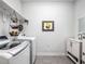 Clean laundry room featuring a modern washer and dryer with storage at 3009 Kildaire Dairy Way, Apex, NC 27539
