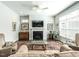 Cozy living room showcasing a fireplace, plush seating, and ample natural light at 3009 Kildaire Dairy Way, Apex, NC 27539