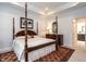 Comfortable main bedroom featuring a four-poster bed, tray ceiling, and area rug at 3009 Kildaire Dairy Way, Apex, NC 27539