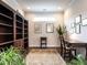 Home office with built-in bookcase, natural light, and dark wood desk at 3009 Kildaire Dairy Way, Apex, NC 27539