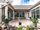 Relaxing outdoor patio with brickwork, mature landscaping, and ample seating at 3009 Kildaire Dairy Way, Apex, NC 27539