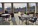 Common area with tables and seating overlooks the community's manicured lawns and attractive homes at 3009 Kildaire Dairy Way, Apex, NC 27539