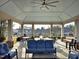 Spacious covered patio featuring comfortable seating, ceiling fan, and views of the neighborhood at 3009 Kildaire Dairy Way, Apex, NC 27539