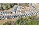 A wide aerial view of a meticulously planned community with tree-lined streets, modern homes, and green spaces at 3144 Star Gazing Ln, Durham, NC 27703