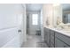 Bright bathroom featuring double vanity, stylish mirrors, and glass-enclosed shower at 3144 Star Gazing Ln, Durham, NC 27703