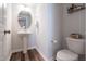 Charming powder room with pedestal sink and wood look flooring at 3144 Star Gazing Ln, Durham, NC 27703