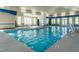 Inviting indoor pool with clear blue water, surrounded by comfortable seating and large windows at 3144 Star Gazing Ln, Durham, NC 27703
