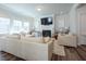 Spacious living room with large sectional, fireplace, and ample natural light at 3144 Star Gazing Ln, Durham, NC 27703