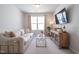 Cozy living room featuring neutral tones, large window, and stylish furniture at 3144 Star Gazing Ln, Durham, NC 27703
