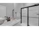 Well lit bathroom with a white countertop, stainless steel fixtures, and a stand up shower at 3360 Brevet St, New Hill, NC 27562