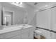 Clean, bright bathroom with a large mirror, quartz countertop, and shower with modern fixtures and finishes at 3360 Brevet St, New Hill, NC 27562
