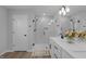 Modern bathroom with double vanity, quartz countertop, frameless shower, and wood-look floors at 3360 Brevet St, New Hill, NC 27562