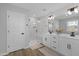 Modern bathroom with double vanity, quartz countertop, frameless shower, and wood-look floors at 3360 Brevet St, New Hill, NC 27562