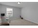Cozy bedroom with neutral walls, carpet, and a window providing natural light for a calm and relaxing space at 3360 Brevet St, New Hill, NC 27562