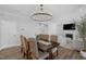 Spacious dining room with a large dining table, chandelier, and open view of the living area at 3360 Brevet St, New Hill, NC 27562
