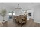 Elegant dining room with a modern chandelier, dining table, and access to the outdoor patio at 3360 Brevet St, New Hill, NC 27562