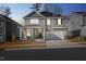 Attractive two-story home with a welcoming front porch, two-car garage, solar panels and well-maintained landscaping at 3360 Brevet St, New Hill, NC 27562
