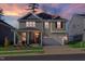 Charming two-story home with a welcoming front porch and attached two-car garage, set against a colorful evening sky at 3360 Brevet St, New Hill, NC 27562
