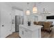 Modern kitchen with white cabinets, stainless steel appliances, and a center island for meal preparation at 3360 Brevet St, New Hill, NC 27562
