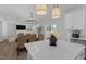 Well-designed kitchen featuring a large island, modern lighting, and a view into the dining and living areas at 3360 Brevet St, New Hill, NC 27562