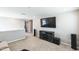 Upstairs living room area with a large flat screen TV and entertainment center, great for relaxing or entertaining at 3360 Brevet St, New Hill, NC 27562