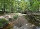 A natural creek winds through the wooded landscape, adding to the property's beauty at 3400 River Manor Ct, Franklinton, NC 27525