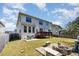 Spacious backyard featuring a wooden deck, patio with seating, and a charming fire pit area at 3557 S Beaver Ln, Raleigh, NC 27604