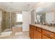 Elegant bathroom with a glass shower, soaking tub, and granite vanity, creating a serene and luxurious space at 3557 S Beaver Ln, Raleigh, NC 27604