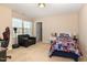 Bright bedroom features a comfortable chair, carpet floors, closet, and plenty of natural light at 3557 S Beaver Ln, Raleigh, NC 27604